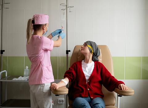 Nurse working at a computer with a clipboard